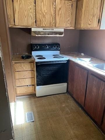 kitchen with electric stove, tile patterned flooring, and extractor fan