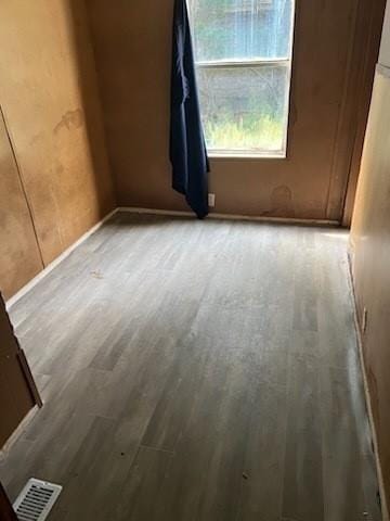 empty room with light hardwood / wood-style flooring