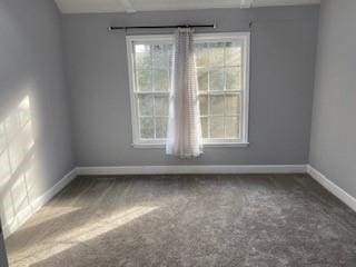 empty room with carpet and baseboards