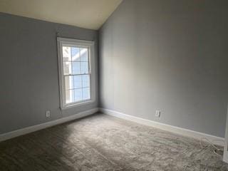 unfurnished room featuring vaulted ceiling, carpet flooring, and baseboards