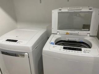 clothes washing area with laundry area and washer and clothes dryer