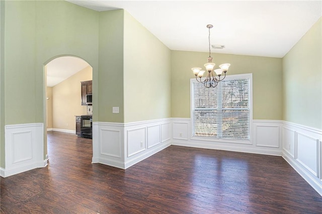 unfurnished room featuring a chandelier, dark hardwood / wood-style floors, and vaulted ceiling