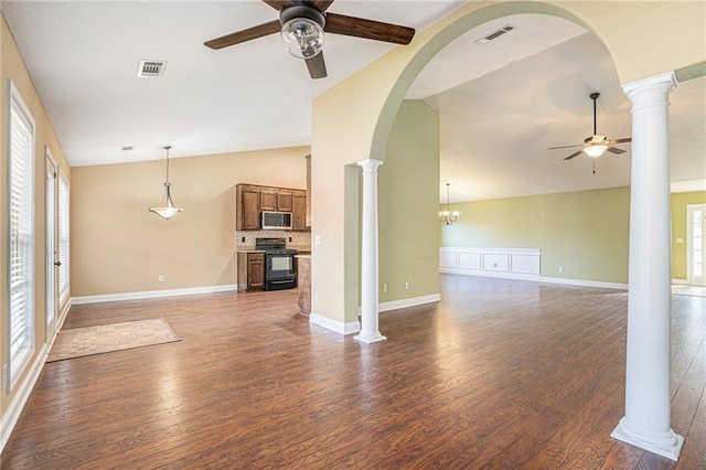 unfurnished living room with ceiling fan with notable chandelier, lofted ceiling, and dark wood-type flooring