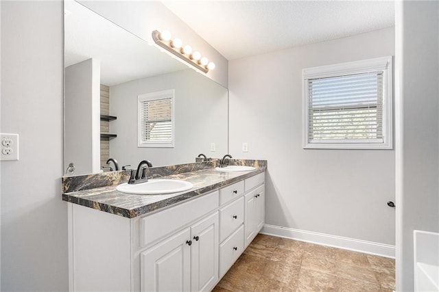 bathroom with vanity and a healthy amount of sunlight