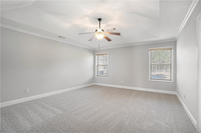 carpeted empty room with a wealth of natural light, a textured ceiling, ceiling fan, and crown molding