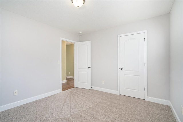 unfurnished bedroom featuring carpet flooring and a closet