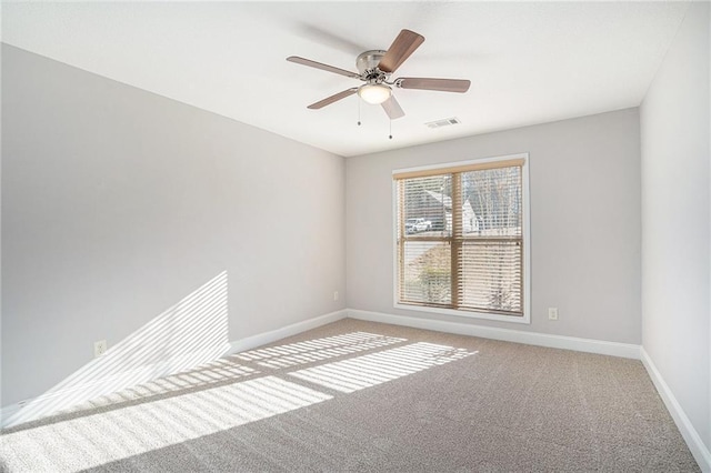 carpeted empty room featuring ceiling fan