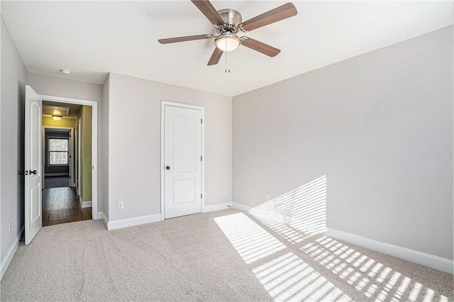 unfurnished bedroom featuring ceiling fan and light carpet