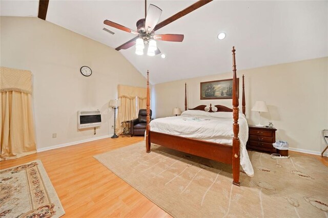 bedroom featuring wood-type flooring, heating unit, ceiling fan, and lofted ceiling