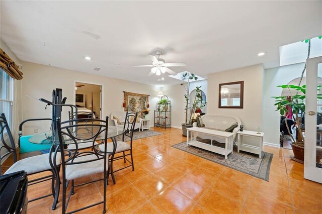 tiled living room featuring ceiling fan