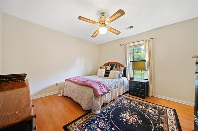 bedroom with hardwood / wood-style flooring and ceiling fan