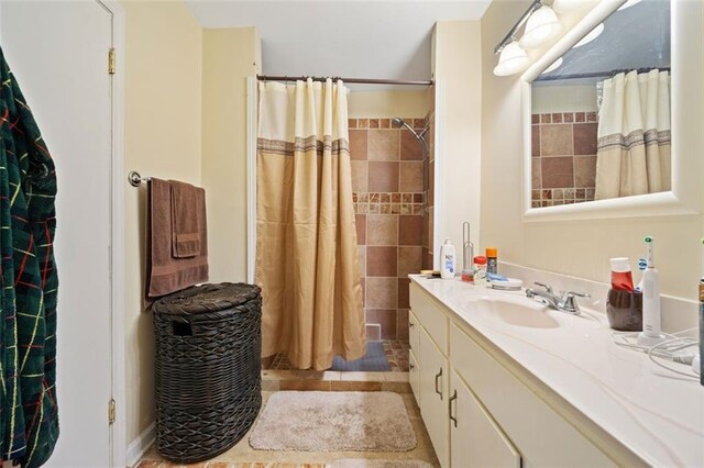 bathroom featuring a shower with shower curtain, tile patterned flooring, and vanity