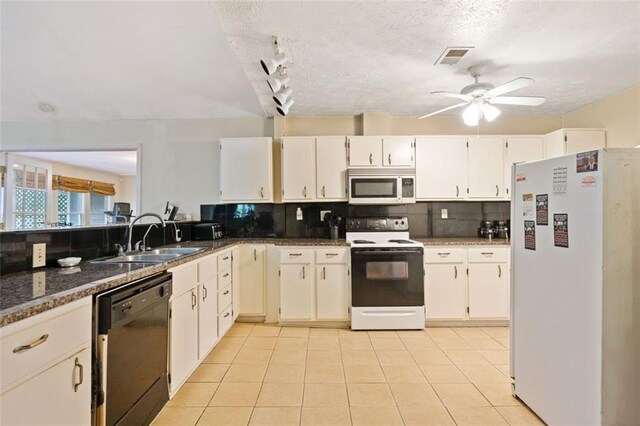 kitchen featuring tasteful backsplash, white appliances, sink, light tile patterned floors, and white cabinets