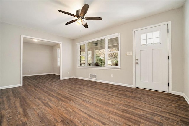 entrance foyer featuring a wealth of natural light, ceiling fan, and dark wood-type flooring