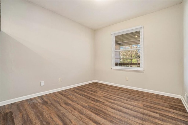 spare room featuring dark hardwood / wood-style flooring