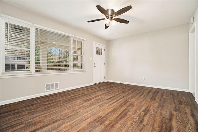 unfurnished room with ceiling fan and dark wood-type flooring