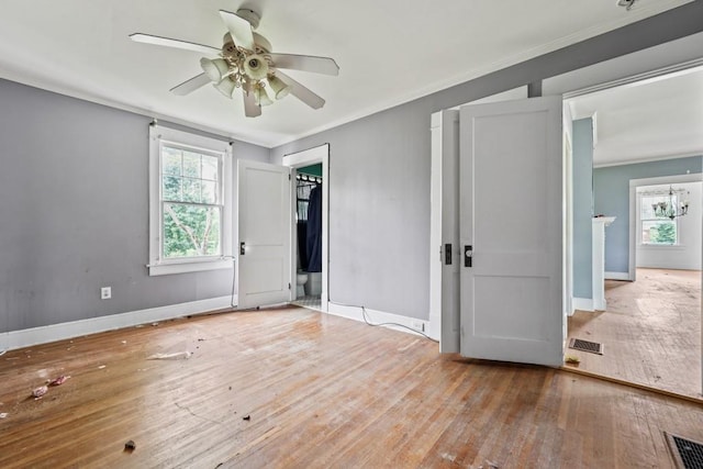 10 Shadburn Ferry Rd, Buford, GA 30518 - unfurnished bedroom with multiple windows, wood-type flooring, ornamental molding, and ceiling fan
