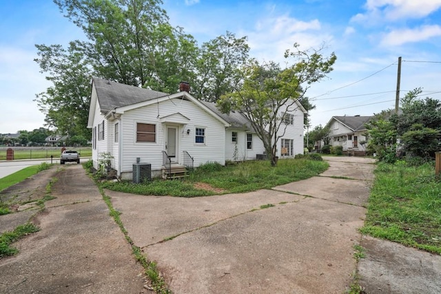 10 Shadburn Ferry Rd, Buford, GA 30518 - bungalow featuring a chimney, roof with shingles, and concrete driveway