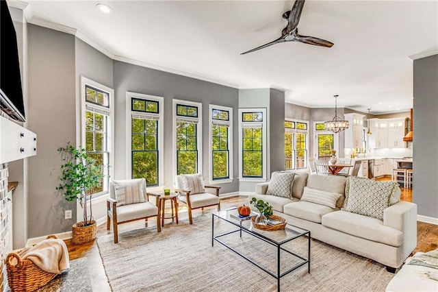 sunroom / solarium featuring ceiling fan with notable chandelier and a fireplace