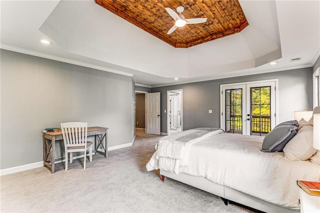 carpeted bedroom featuring access to exterior, a raised ceiling, baseboards, and french doors