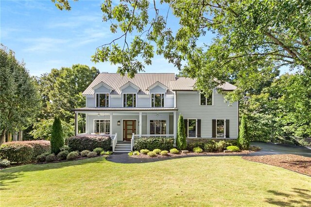 view of front of house with covered porch and a front yard