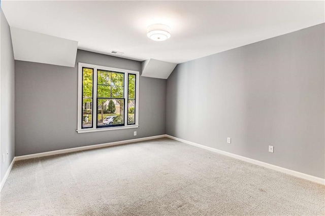 unfurnished room featuring carpet flooring, visible vents, and baseboards