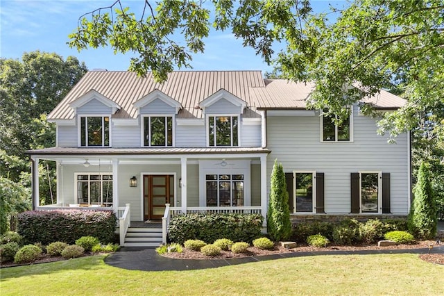 modern farmhouse style home featuring metal roof, a porch, and a front yard