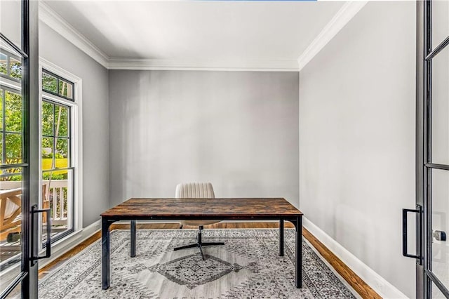 office area featuring crown molding, baseboards, and wood finished floors