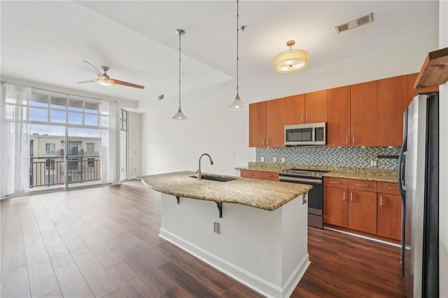 711 Cosmopolitan Dr NE Unit 802, Atlanta, GA 30324 - kitchen featuring stainless steel appliances, ceiling fan, dark wood-type flooring, and brown cabinetry