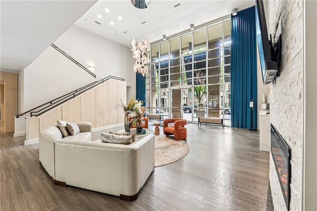 711 Cosmopolitan Dr NE Unit 802, Atlanta, GA 30324 - living area with a towering ceiling, wood finished floors, a ceiling fan, a stone fireplace, and recessed lighting