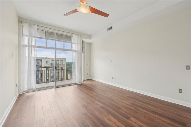 711 Cosmopolitan Dr NE Unit 802, Atlanta, GA 30324 - unfurnished room with ceiling fan, wood finished floors, and a wall of windows