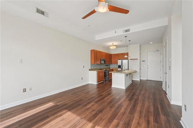 711 Cosmopolitan Dr NE Unit 802, Atlanta, GA 30324 - kitchen with stainless steel appliances, open floor plan, brown cabinets, light countertops, and a ceiling fan