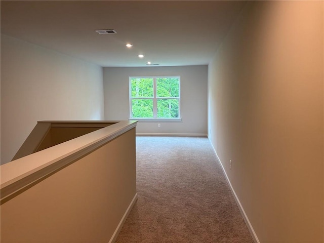 hallway with baseboards, carpet flooring, recessed lighting, and visible vents