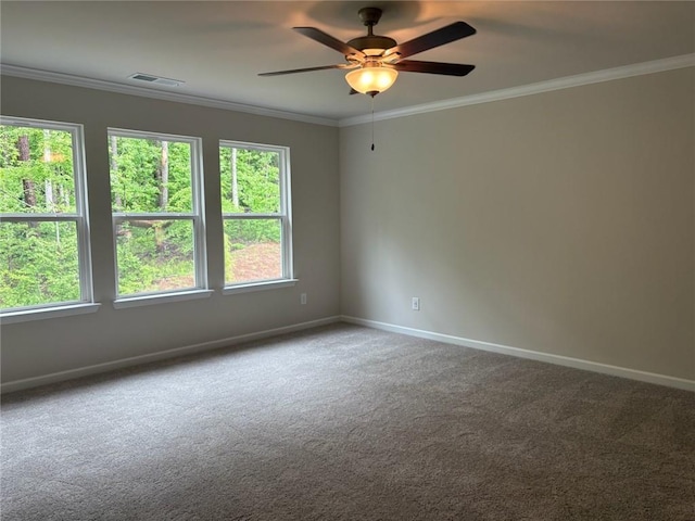 unfurnished room with visible vents, crown molding, baseboards, a ceiling fan, and carpet