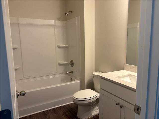 bathroom with vanity, shower / bathing tub combination, toilet, and wood finished floors