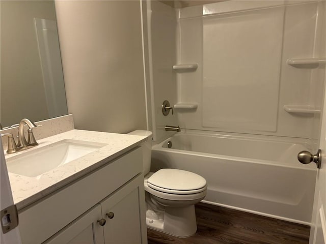 bathroom featuring vanity, bathtub / shower combination, toilet, and wood finished floors