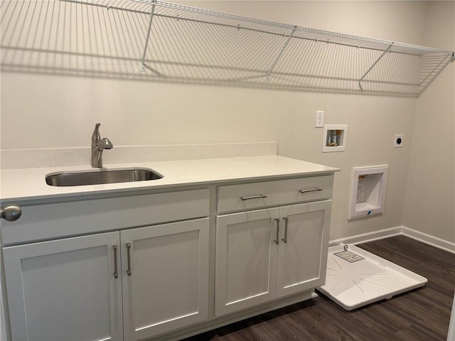 clothes washing area featuring hookup for an electric dryer, dark wood-style flooring, washer hookup, and a sink