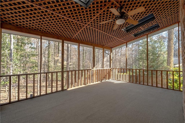 unfurnished sunroom featuring ceiling fan