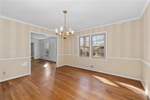 unfurnished dining area featuring wood-type flooring, ornamental molding, and a healthy amount of sunlight