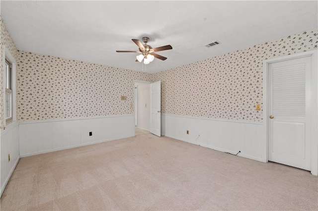 interior space with light colored carpet and ceiling fan