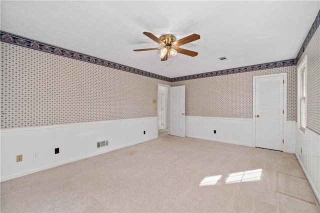 unfurnished room featuring light carpet and ceiling fan