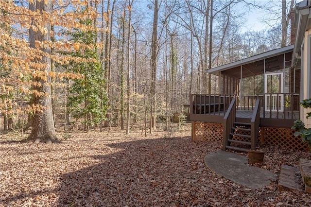 view of yard featuring a deck and a sunroom