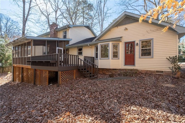 back of house featuring a wooden deck and a sunroom