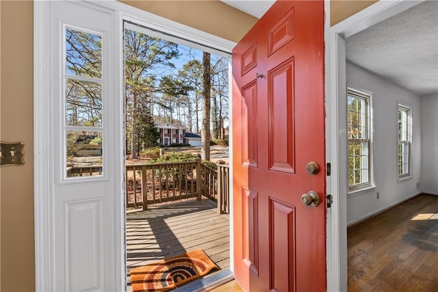 entryway with hardwood / wood-style floors and a textured ceiling