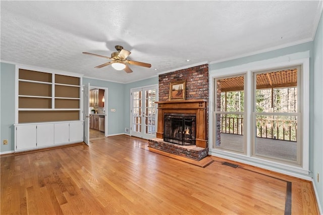 unfurnished living room with crown molding, light hardwood / wood-style floors, ceiling fan, and a wealth of natural light