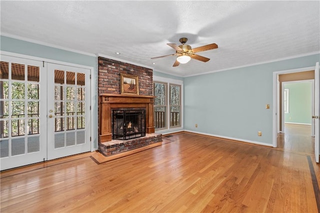 unfurnished living room with crown molding, light wood-type flooring, and a brick fireplace