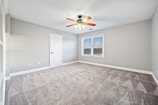 spare room with light colored carpet and ceiling fan