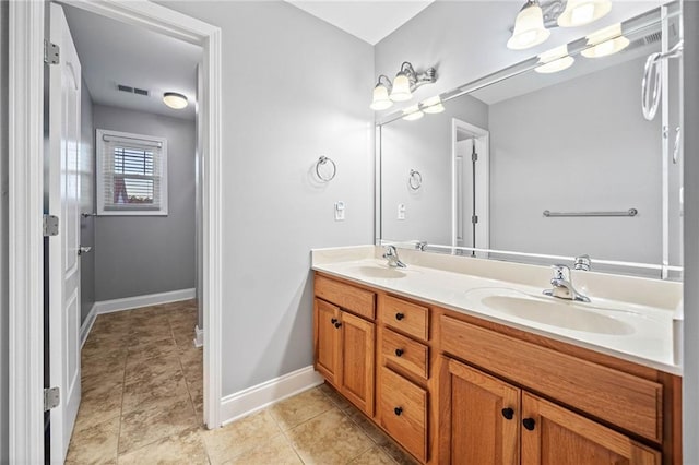 bathroom with vanity and tile patterned floors