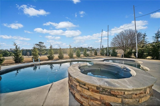 view of swimming pool with an in ground hot tub