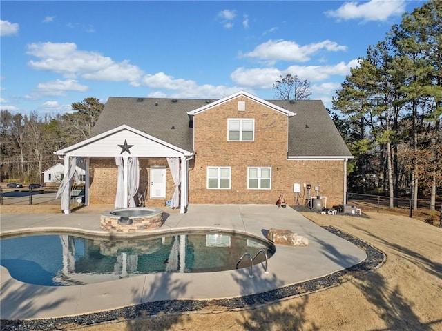 back of property featuring a pool with hot tub, central AC, and a patio area